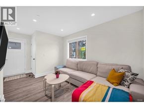 Bc apartment for rent - A living room with a grey couch and a coffee table.
