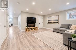 Georgina (Keswick South) apartment for rent - A spacious living room with a grey couch and a wooden floor.