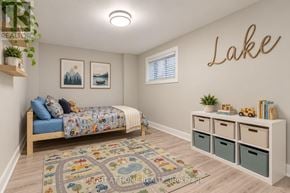 Georgina (Keswick South) apartment for rent - A bedroom with a bed, a rug, a wall-mounted shelf, and a wall-mounted light fixture.