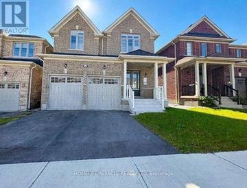 Georgina (Sutton & Jackson's Point) apartment for rent - A large, well-maintained house with a driveway in front.