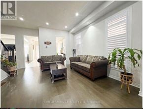 Georgina (Sutton & Jackson's Point) apartment for rent - A living room with a couch, a coffee table, and a potted plant.