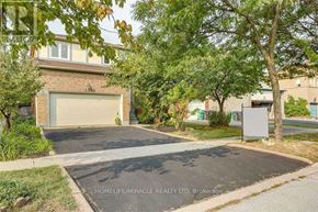 Mississauga (Meadowvale) apartment for rent - A residential area with a house, garage, and trees.