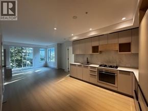 Port Moody apartment for rent - A modern kitchen with wooden floors and a large island.