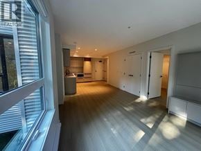 Port Moody apartment for rent - A spacious, well-lit room with wooden flooring and white walls.
