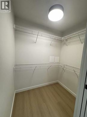 Port Moody apartment for rent - A white room with a light on the ceiling and a door on the right.