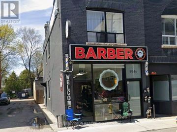 Toronto (Playter Estates-Danforth) multi-family for rent - A barber shop with a sign that reads "Barber" and a clock on the sign.