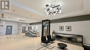 Mississauga (Hurontario) condo for rent - A spacious room with a black and white color scheme and a chandelier hanging from the ceiling.