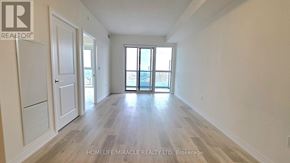 Mississauga (Hurontario) condo for rent - A spacious room with wooden flooring and a large window.