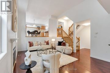 Waterloo apartment for rent - A living room with a white couch and a wooden staircase.