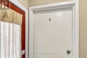 Kitchener apartment for rent - A white door with the number 3 on it.