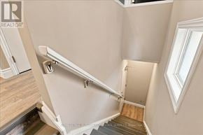 Kitchener apartment for rent - A staircase with a metal handrail and wooden steps.