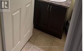 Hamilton (Hannon) apartment for rent - A bathroom with a white door and brown cabinets.