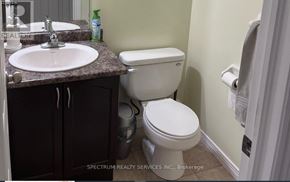 Hamilton (Hannon) apartment for rent - A white toilet sits next to a sink in a bathroom.