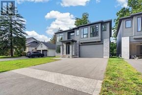 Ottawa apartment for rent - A modern house with a grey garage door is for sale.