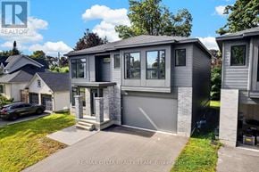 Ottawa apartment for rent - A modern house with a grey exterior and a black car parked in the driveway.