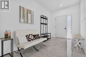 Ottawa apartment for rent - A white couch with a pillow and a vase on a small table in a room.