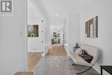 Ottawa apartment for rent - A modern living room with a white couch and a painting on the wall.