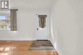 King (Schomberg) apartment for rent - A room with a white door and a window with curtains.
