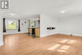 King (Schomberg) apartment for rent - A room with wooden flooring and white walls, with a window on the left side.