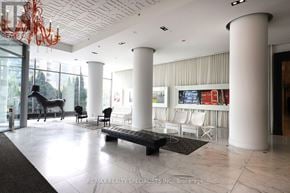 Toronto (Mimico) condo for rent - A large white room with a long bench and a chandelier.