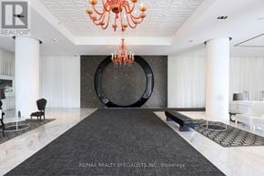 Toronto (Mimico) condo for rent - A large, elegant room with a chandelier and a circular design on the wall.
