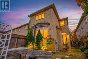 Caledon townhouse for rent - A house with a stone facade and a lit up entrance.
