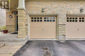 Caledon townhouse for rent - A garage door is closed and the wall is made of bricks.
