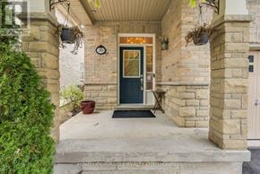 Caledon townhouse for rent - A house entrance with a black door and a stone pillar.