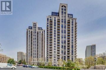 Toronto (Banbury-Don Mills) condo for rent - A tall residential building with a parking lot in front.