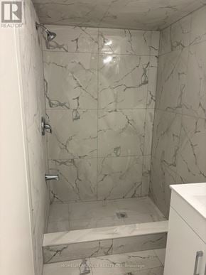 Barrie (Grove East) apartment for rent - A bathroom with marble tiles on the walls.