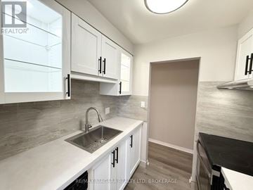 St. Catharines (Carlton/Bunting) townhouse for rent - A kitchen with white cabinets and a sink.