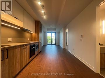Toronto (Forest Hill South) condo for rent - A long hallway with wood floors and white walls.