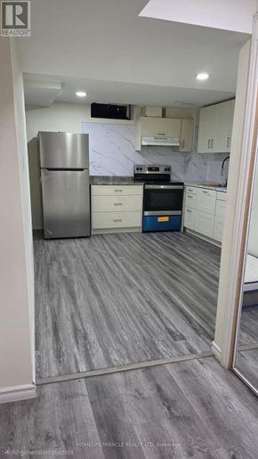 Brampton (Heart Lake East) apartment for rent - A hallway with a staircase and doors on the right side.