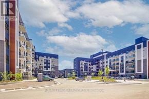 Oakville (Go Glenorchy) condo for rent - A street view of a residential area with apartment buildings and cars parked on the side of the road.