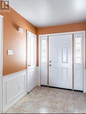 London South (South Y) townhouse for rent - A hallway with two doors and a wall-mounted light switch.