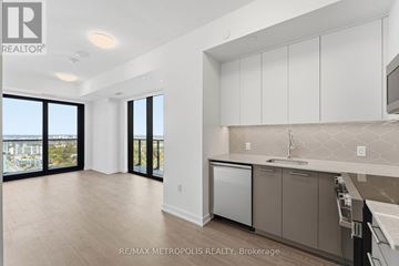 Kitchener condo for rent - A kitchen with white cabinets and a dishwasher.