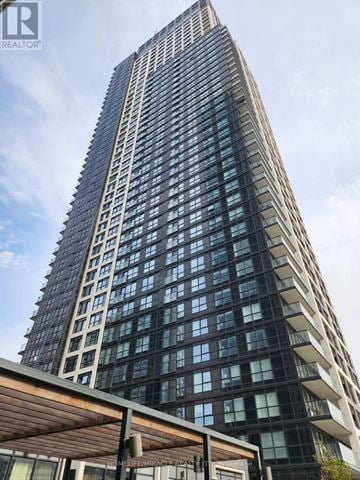 Toronto (Islington-City Centre West) condo for rent - A tall building with a lot of windows and a sign that says REALTOR.