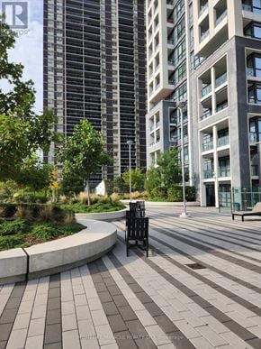 Toronto (Islington-City Centre West) condo for rent - A tall building with a balcony and a tree in front of it.