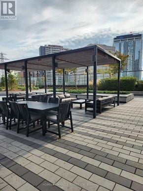 Toronto (Islington-City Centre West) condo for rent - A patio with a table and chairs under a roof.