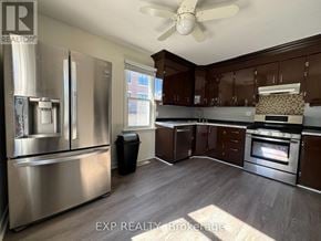 Richmond Hill (Oak Ridges Lake Wilcox) apartment for rent - A kitchen with a stainless steel refrigerator and wooden cabinets.