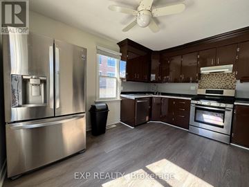 Richmond Hill (Oak Ridges Lake Wilcox) apartment for rent - A kitchen with a stainless steel refrigerator and wooden cabinets.