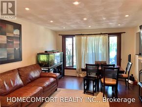 Toronto (Willowridge-Martingrove-Richview) apartment for rent - A living room with a brown leather couch and a fish tank.