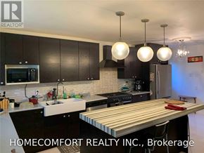 Toronto (Willowridge-Martingrove-Richview) apartment for rent - A modern kitchen with a wooden island in the middle.