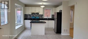 Markham (Wismer) apartment for rent - A kitchen with a black counter top and a black refrigerator.