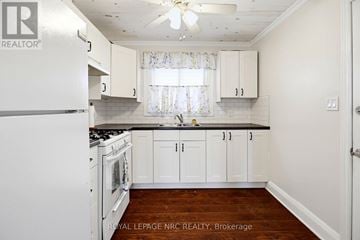 Fort Erie (Crystal Beach) apartment for rent - A kitchen with white cabinets and a white refrigerator.