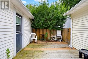 Fort Erie (Crystal Beach) apartment for rent - A small backyard with a wooden deck and two white chairs.