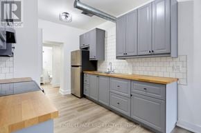 Fort Erie (Crystal Beach) multi-family for rent - A kitchen with a wooden counter top and grey cabinets.