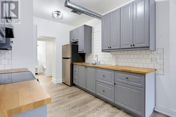 Fort Erie (Crystal Beach) multi-family for rent - A kitchen with a wooden counter top and grey cabinets.