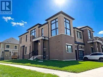 Richmond Hill townhouse for rent - A large brick house with a car parked in front.