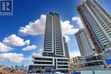 Toronto (Niagara) condo for rent - A tall building under construction with a clear blue sky in the background.